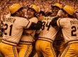 Pittsburgh Pirates players celebrate on the field in their classic gold and black uniforms after winning the 1979 World Series, capturing the joy of the We Are Family championship season.